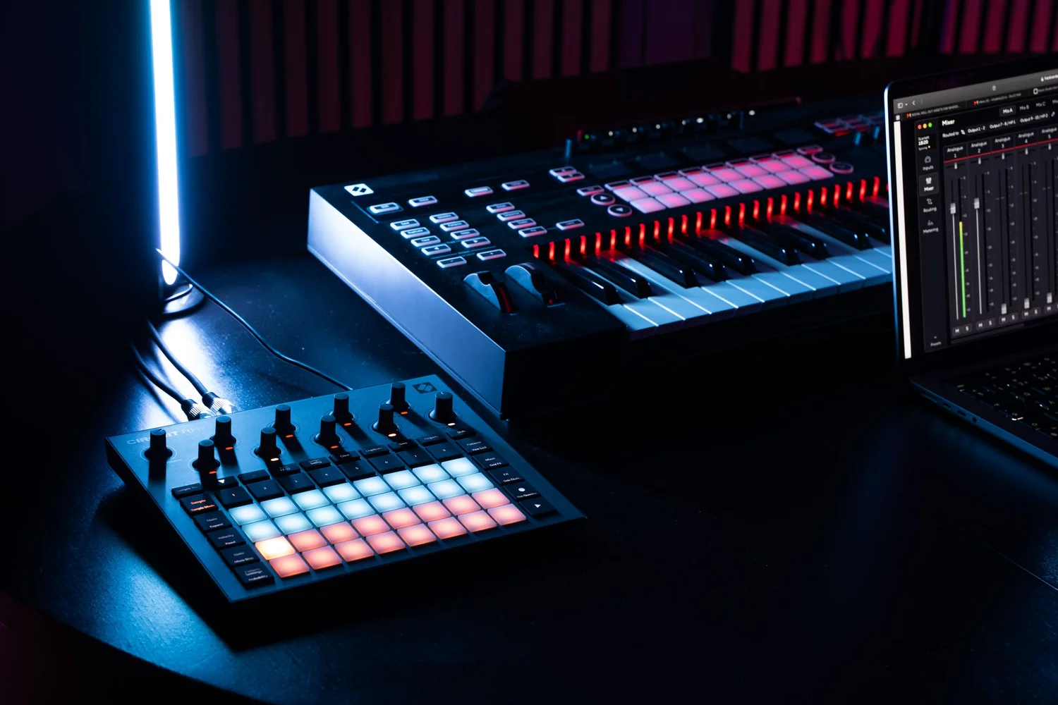 Close-up of a Novation Circuit Rhythm sampler with its pads lit, the Novation 61SL MkIII keyboard behind it, at STU 22 Wapping