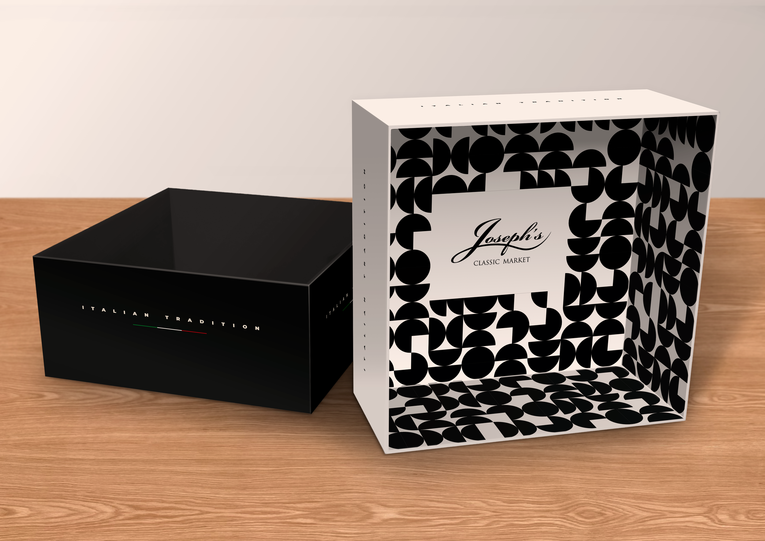 Black box with Italian tradition text on it and a white box with Joseph's classic market logo, both placed on a wooden surface.