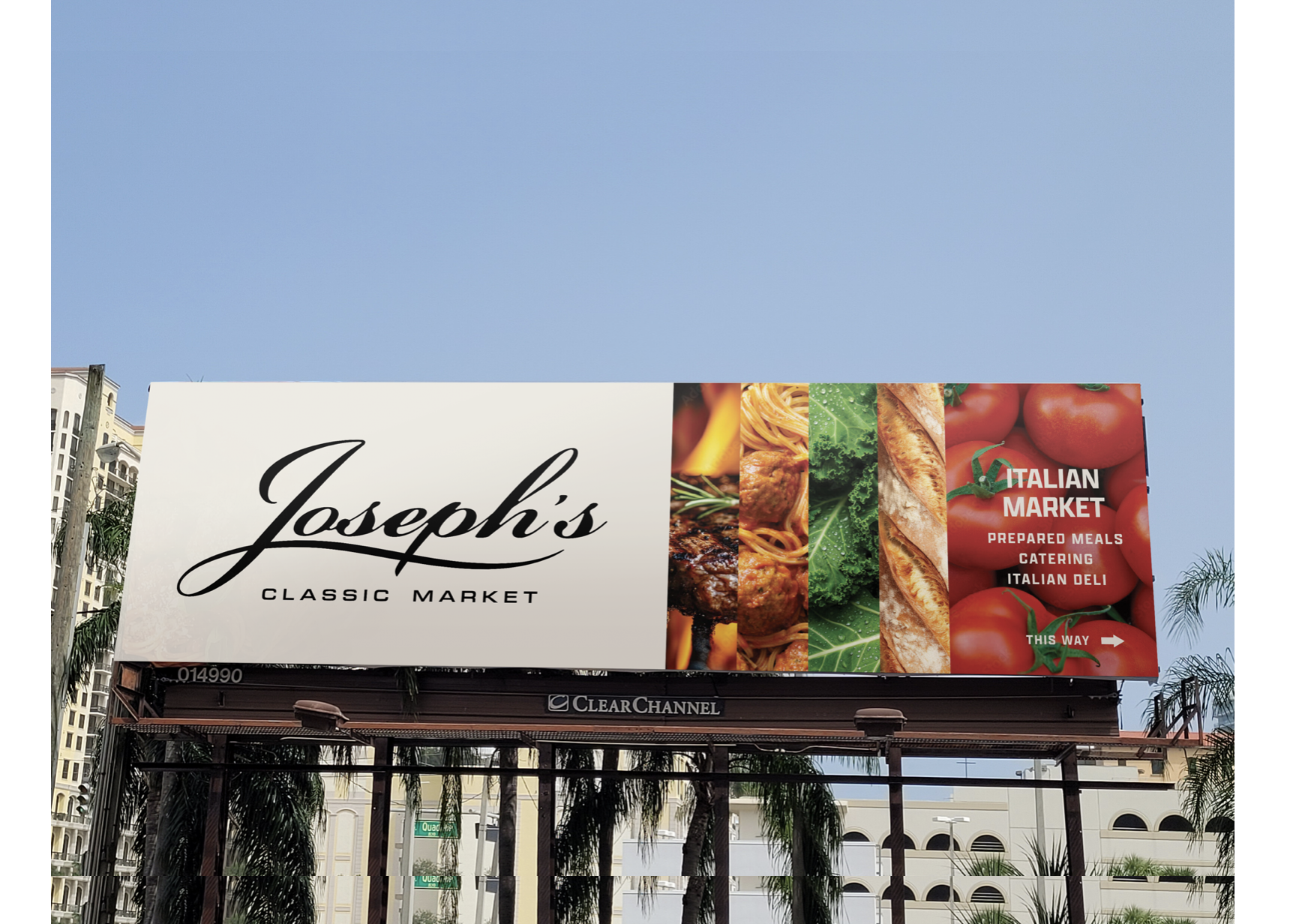 Billboard advertising Joseph's Classic Market and Italian Market with images of food, including pasta, lettuce, bread, and tomatoes, against a blue sky with some trees and buildings in the background. Robert Ranfranz branding, design and retail.