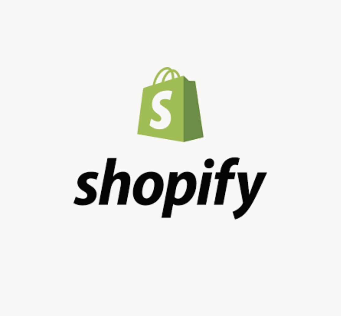 Shopify logo featuring a green shopping bag with a white 'S' and the word 'shopify' in black lowercase letters.