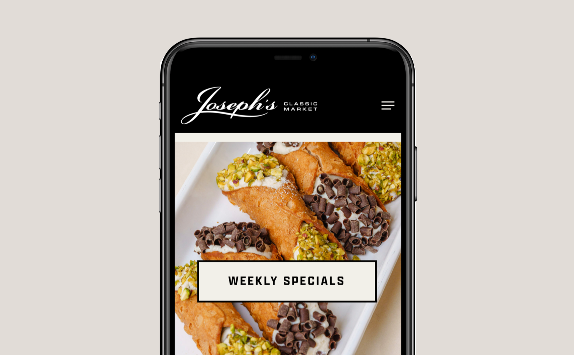 A smartphone showing the homepage of Joseph's Classic Market, featuring a tray of cannoli with chopped pistachios and chocolate shavings, advertises weekly specials. Robert Ranfranz branding and design.