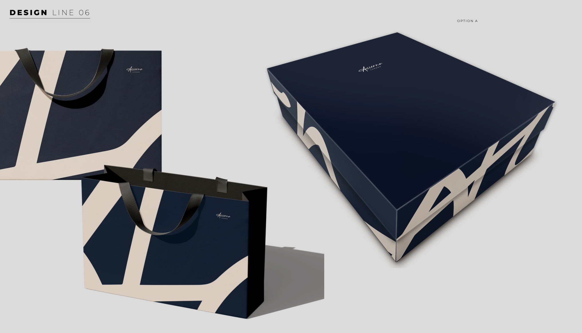 Three shopping bags and a box with navy blue and beige abstract design, one bag with black handles, one bag without handles, and the box with a sliding lid, all on a gray background.