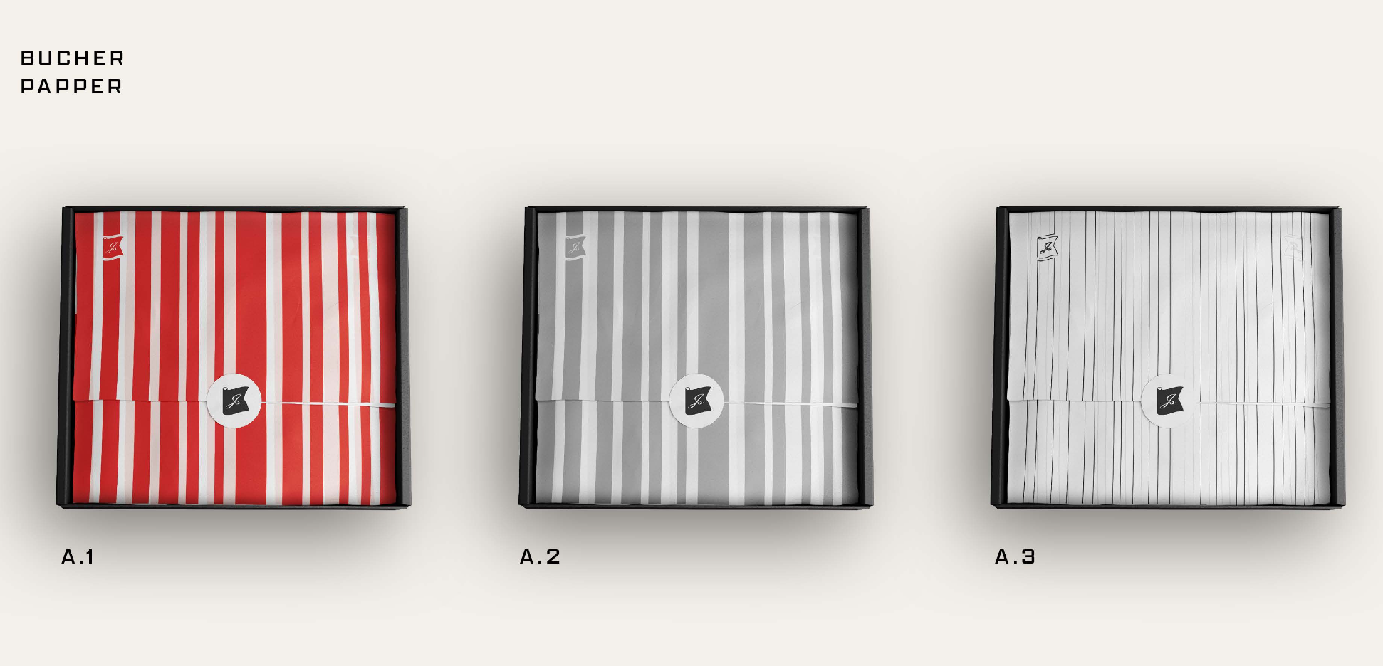 Three boxes of striped paper in red, gray, and white colors arranged side by side on a white surface. Each box contains sheets of paper with vertical stripes, labeled A.1, A.2, and A.3 respectively.