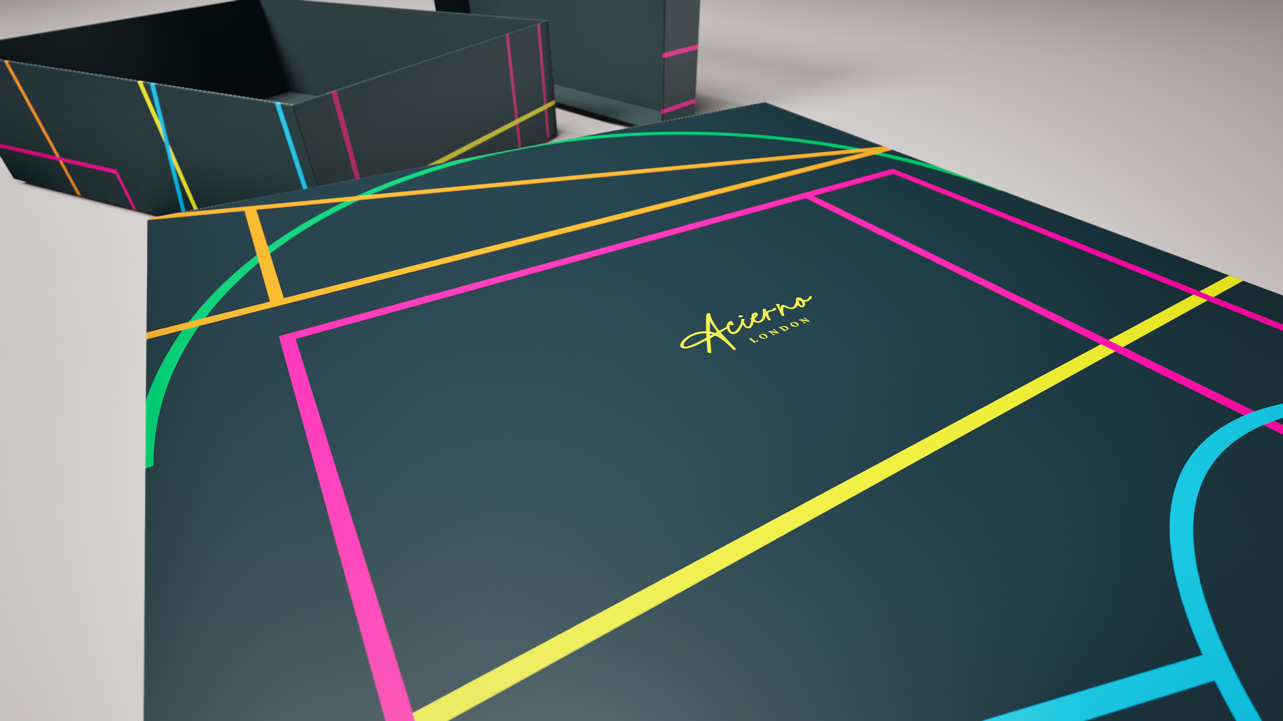 Close-up of a dark retail box with neon-colored line patterns, with the yellow, handwritten-style text 'Acierno London' on the top. Robert Ranfranz branding, design and packaging.