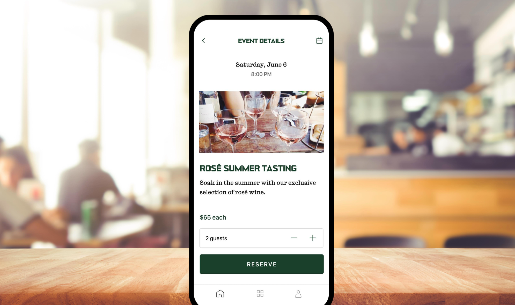 A smartphone on a wooden table displaying an event reservation app for a rosé wine tasting event on June 6 at 8:00 PM, with a photo of wine glasses on a table.