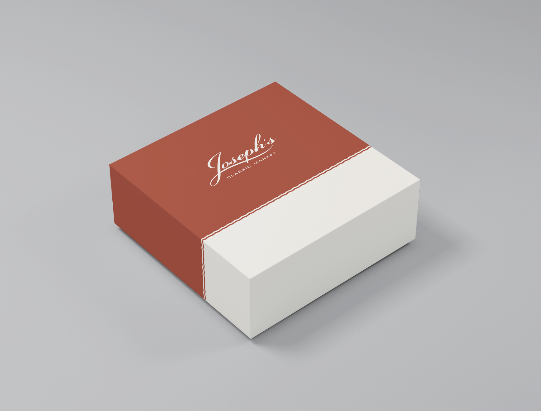 A rectangular box with a red lid and white bottom, labeled 'Joseph's Classic Market' in white cursive font on the lid.