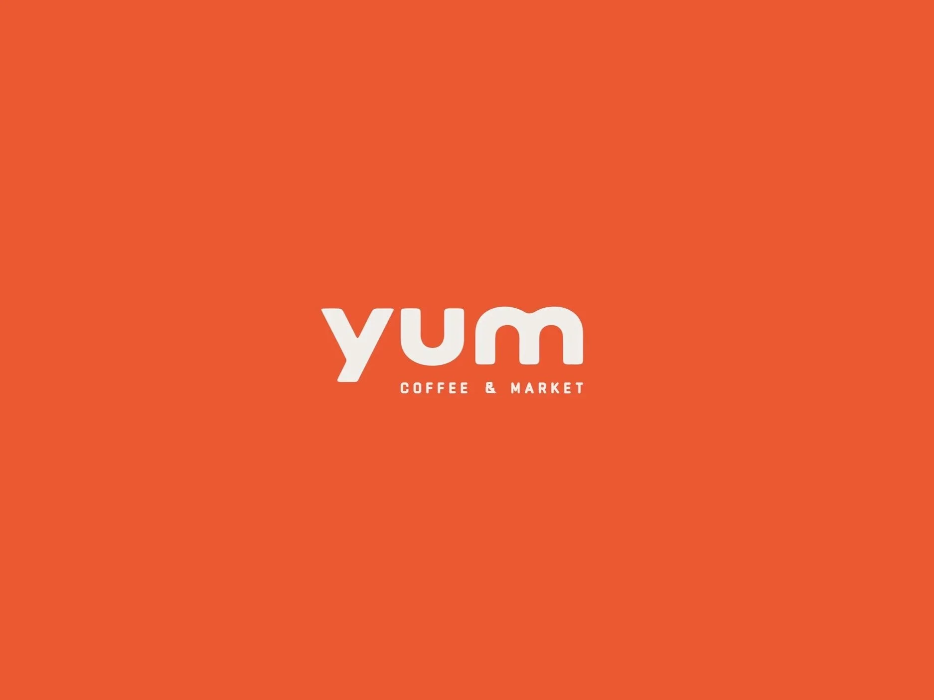 Bright orange background with white text that says 'yum' and smaller text below that reads 'COFFEE & MARKET'. Robert Ranfranz creative studio.