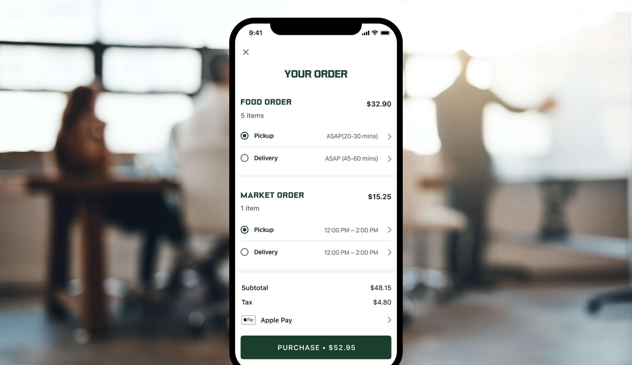 Smartphone screen displaying a food and market order summary in a blurred office setting with people in the background.