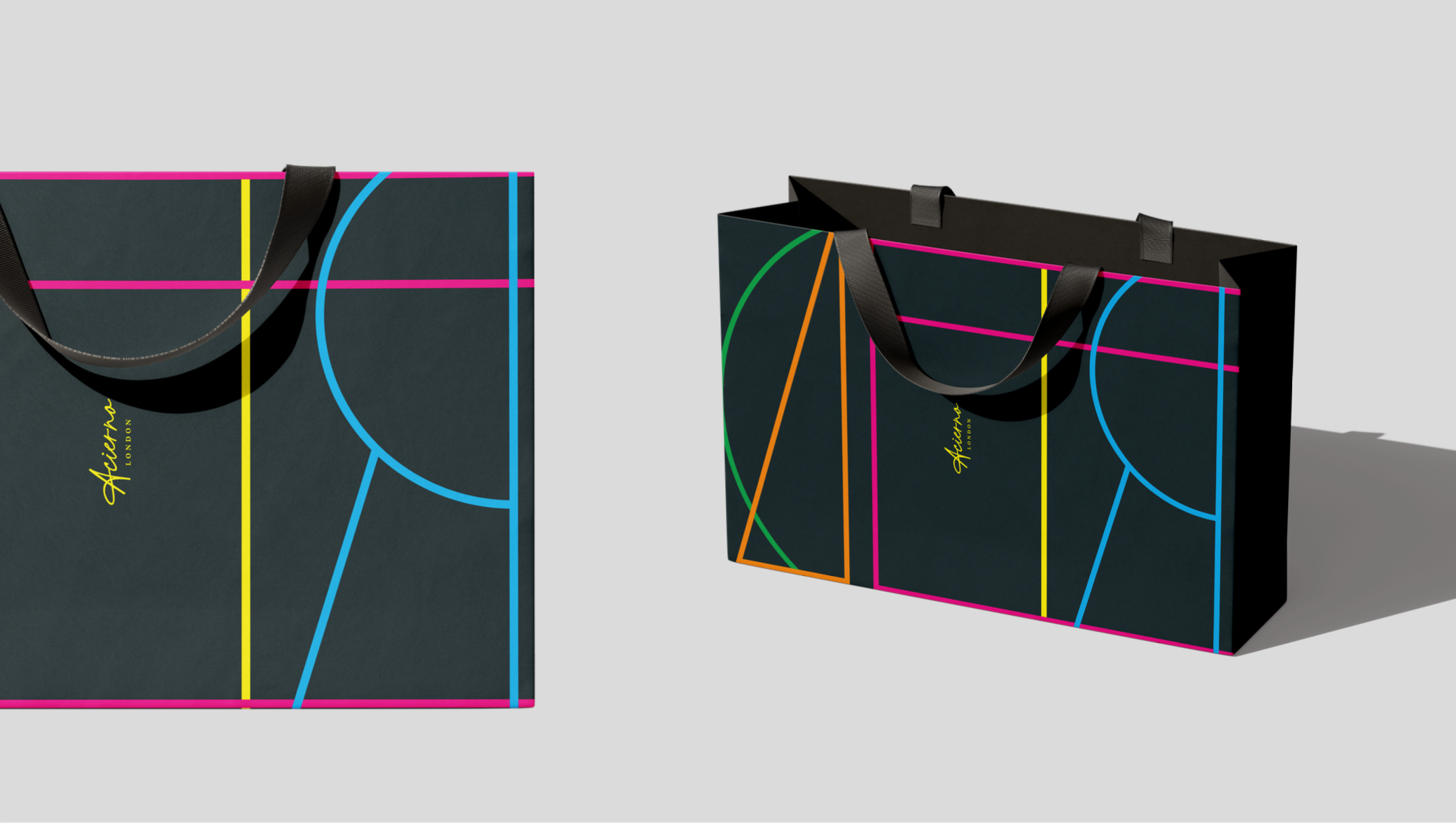 Two black shopping bags with neon geometric line designs and yellow text reading 'Aston London' are placed side by side on a light gray surface. The bag on the left has a black handle, while the one on the right has two black handles, casting shadows on the surface.