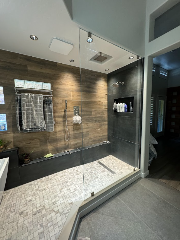 frameless-walk-in-shower-stone-wall-niche.jpg