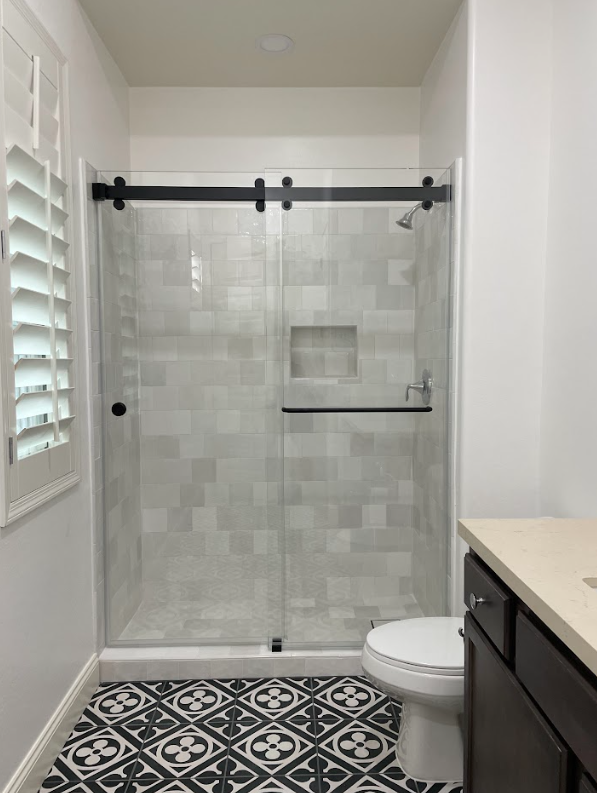 sliding-shower-door-black-rail-pattern-tile.jpg