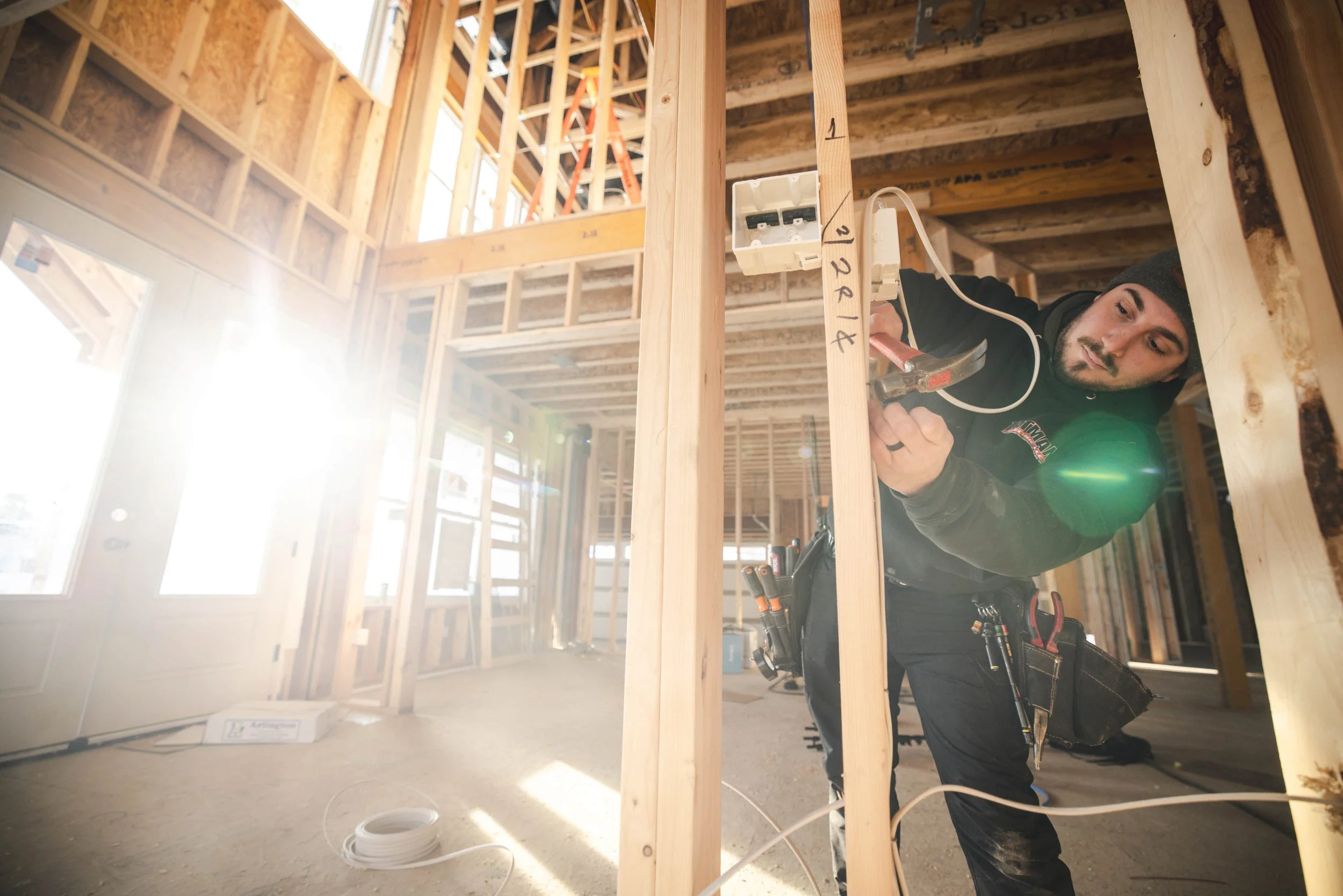 Tatman Electric electrician installing wiring in framed new construction home Pittsburgh PA