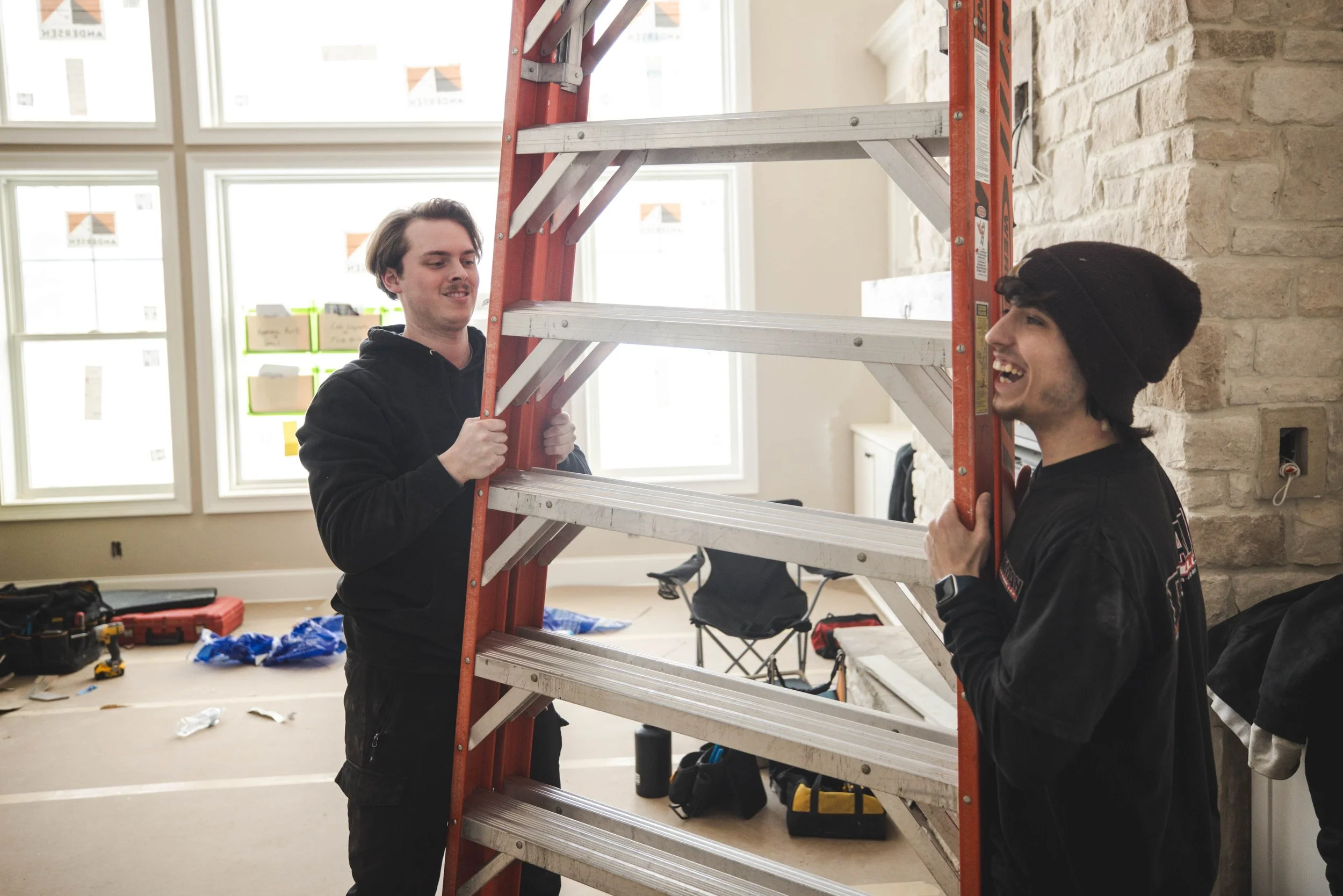 Tatman Electric electricians setting up ladder inside high-end residential renovation Pittsburgh PA