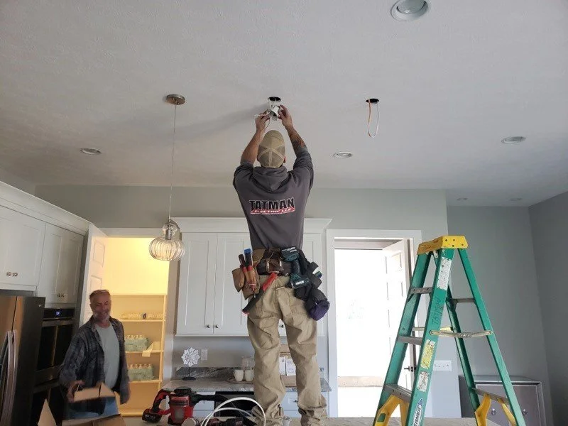Tatman Electric licensed electrician installing recessed LED lighting in Pittsburgh PA residential kitchen