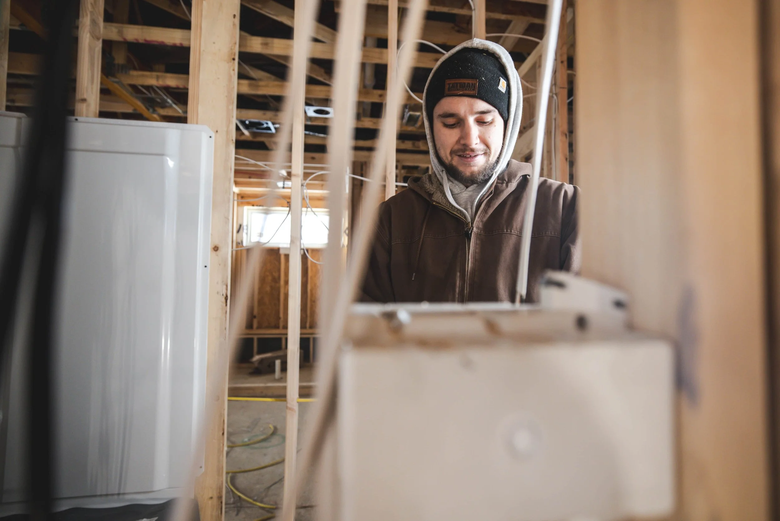 Tatman Electric electrician working on residential wiring inside new construction framing Pittsburgh PA