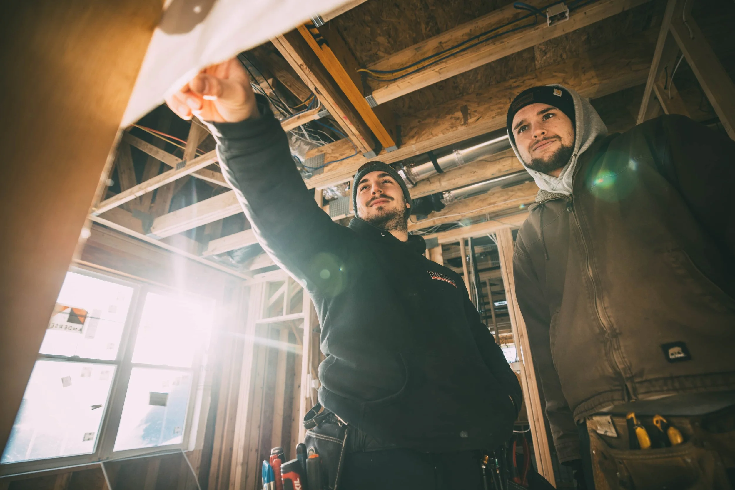 Tatman Electric electricians inspecting ceiling wiring on new construction job site Pittsburgh PA