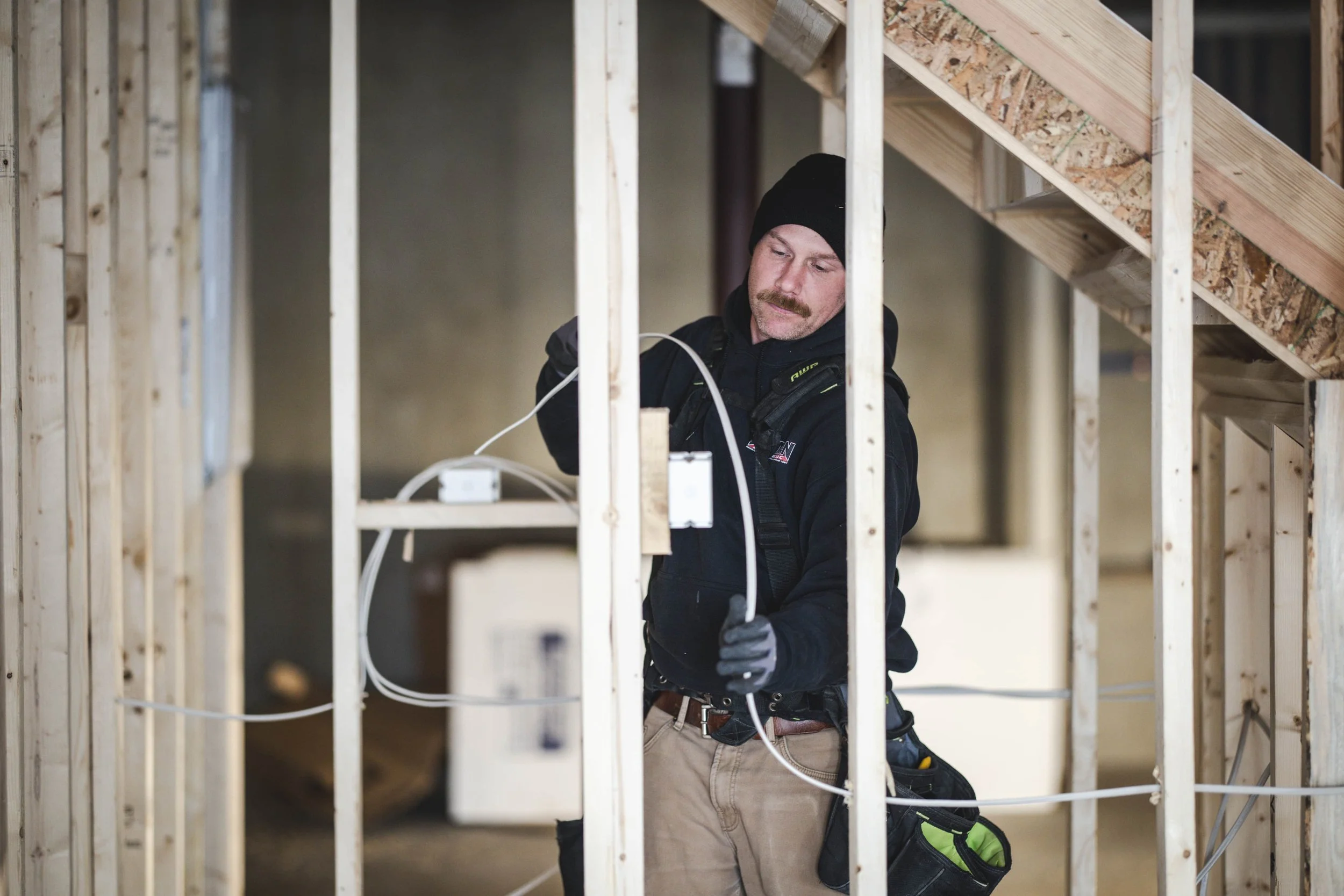 Tatman Electric electrician running electrical wiring inside residential new construction wood framing Pittsburgh PA