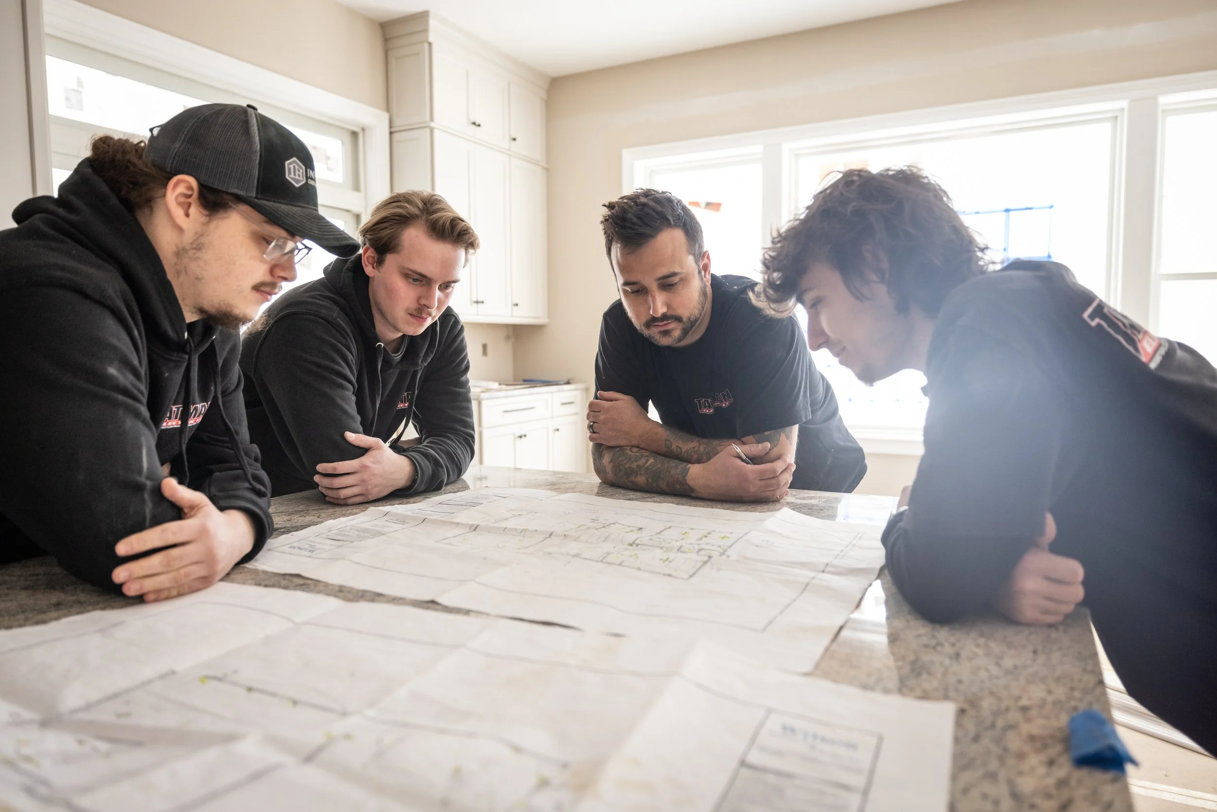 Tatman Electric team reviewing residential electrical blueprints with homeowner Pittsburgh PA