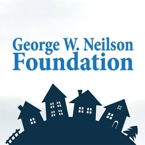 Logo of the George W. Neilson Foundation with black silhouettes of houses on a hill.