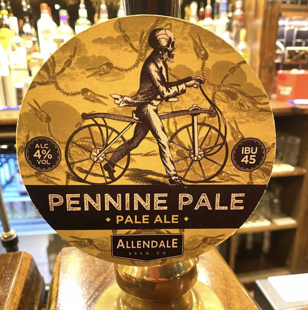 Beer label for Pennine Pale, a pale ale by Allendale Brew Co, with an illustration of a skeleton riding a bicycle, yellow background, and info about alcohol content (4%), and IBU (45).