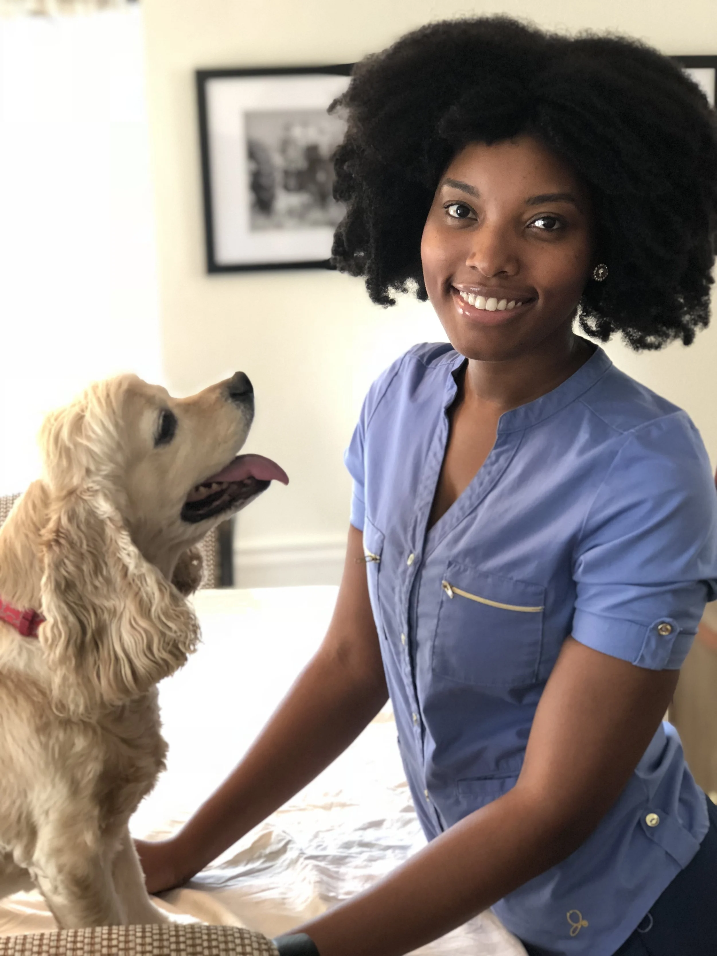 cocker spaniel smiling up at a smiling dr aziza glass during a house call appointment at cawlm veterinary hospital