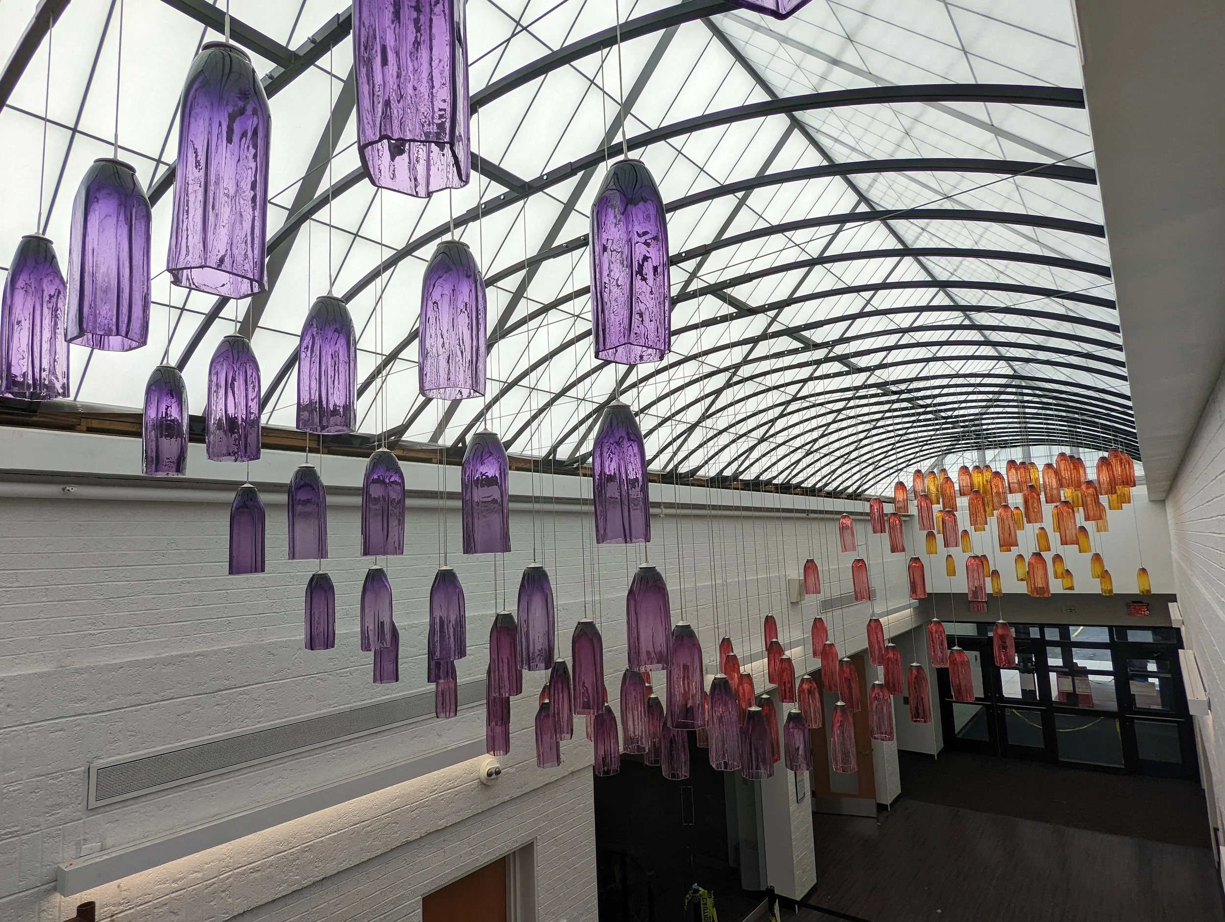 Fabrication Work:
In 2022 I was contracted to fabricate 28 of these 14-foot steel arches in accordance with engineer specifications to support this permanent public glass installation at Owens Community College in Toledo, OH