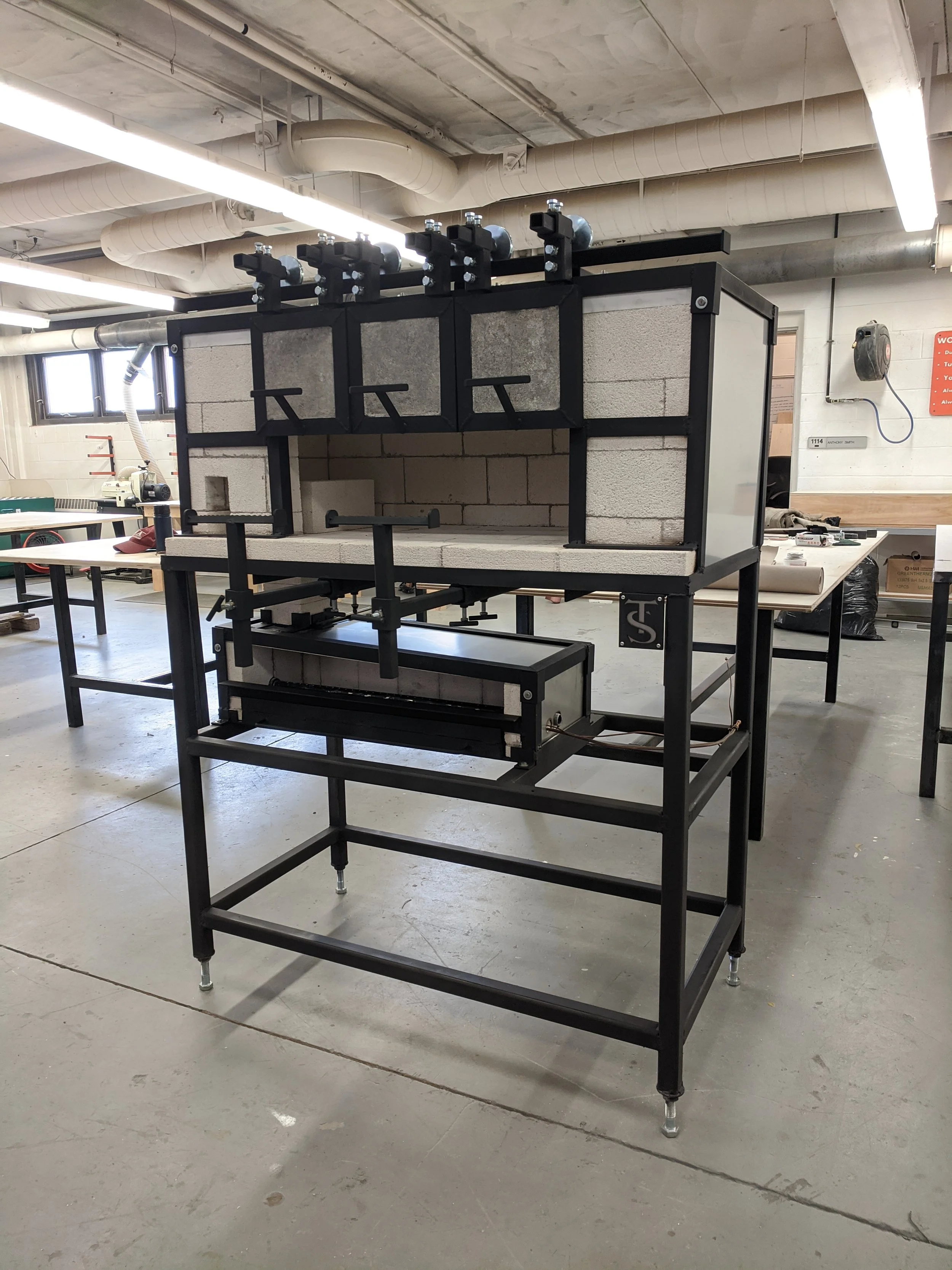 Garage:
Designed and fabricated new garage with movable doors and attached pipe warmer with ribbon burner. 2021.