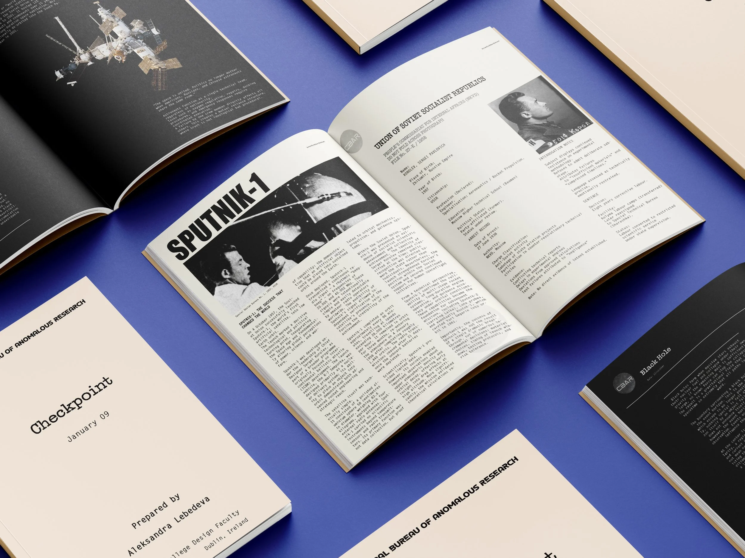 Open magazines or research booklets with articles, images, and text related to space exploration, Soviet history, and scientific topics, placed on a blue surface.