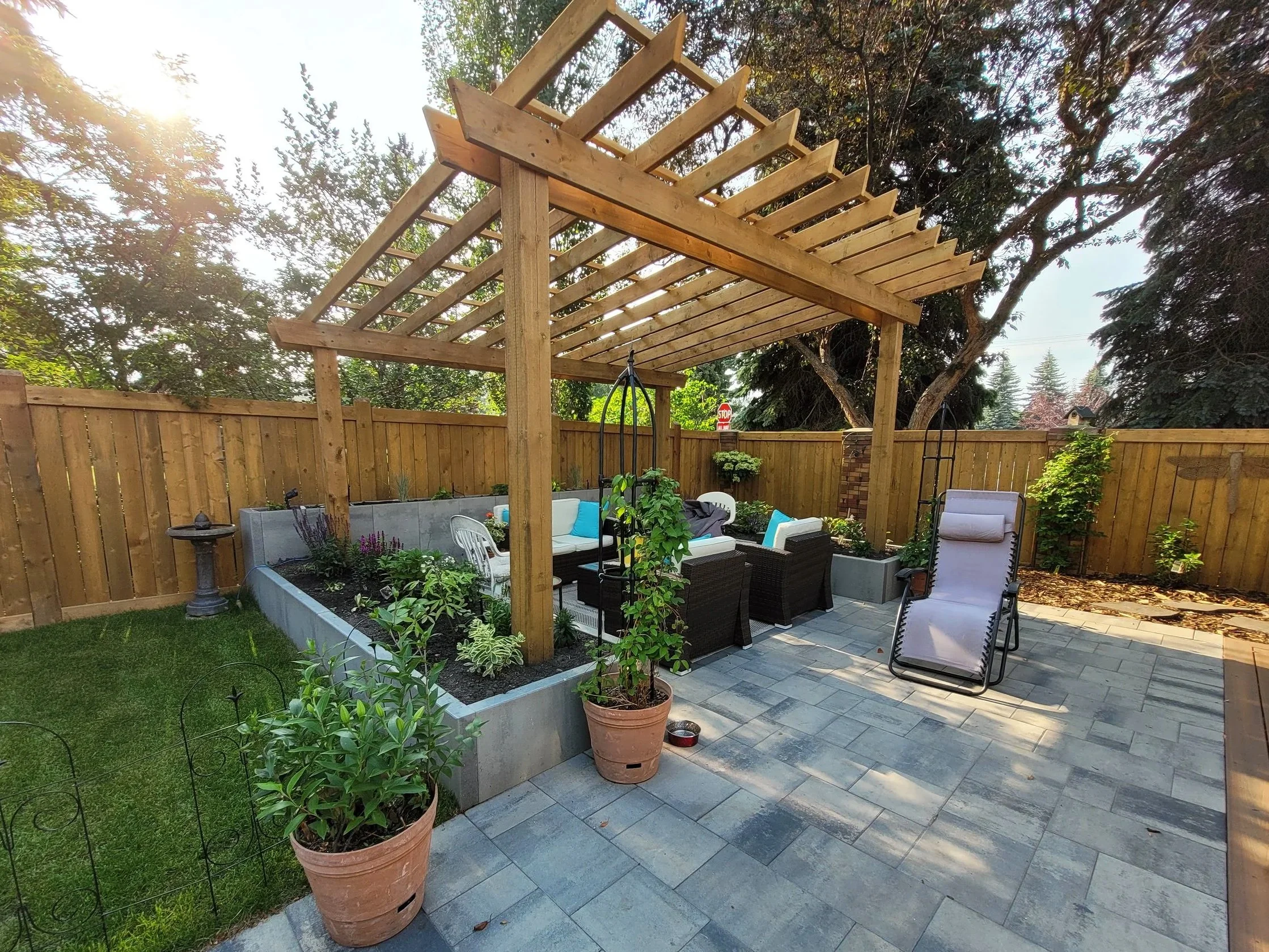 Wooden pergola, concrete flower beds, paving stones, pavers patio, landscaping