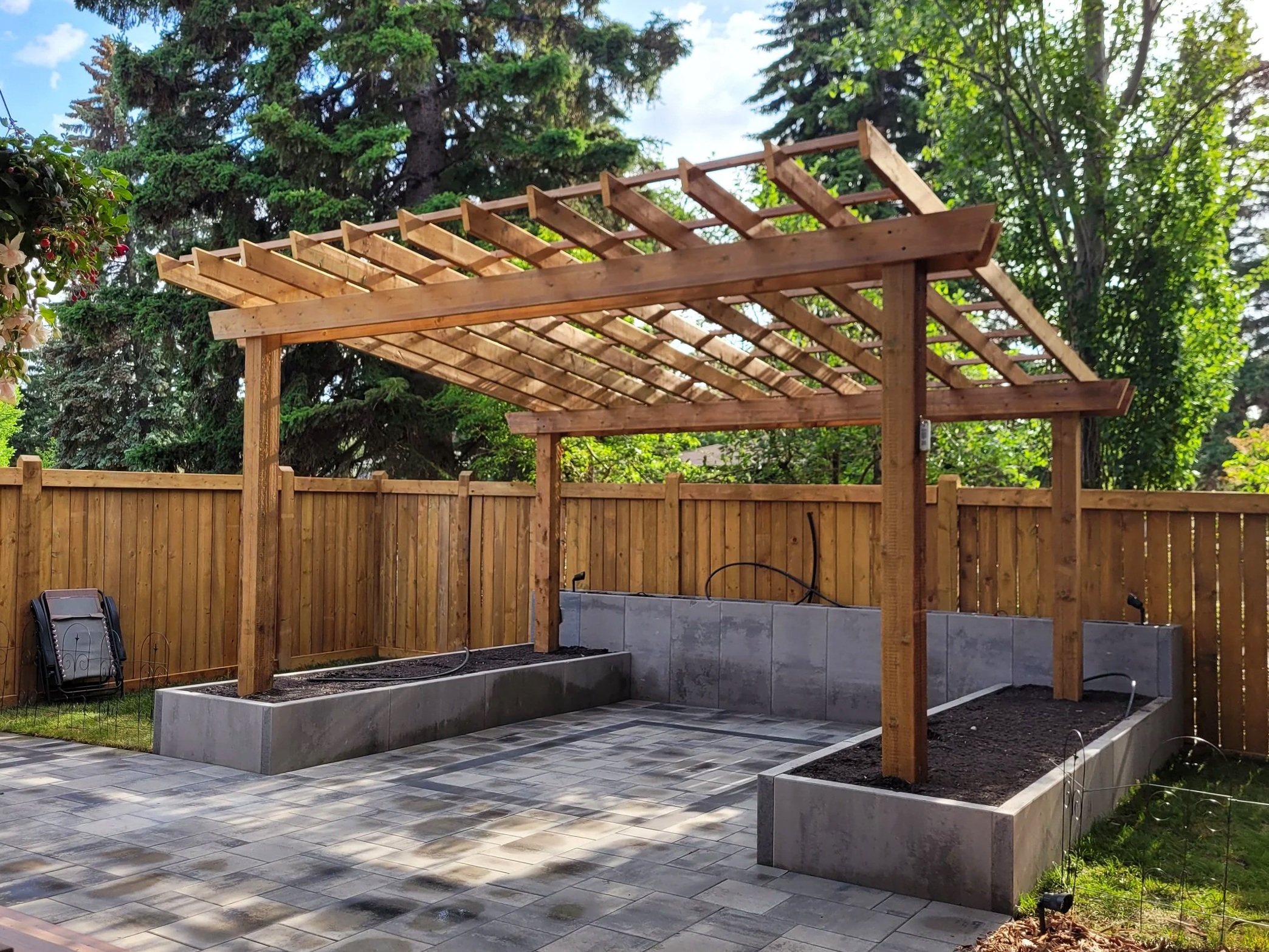 Wooden pergola, concrete flower beds, paving stones, pavers patio, landscaping