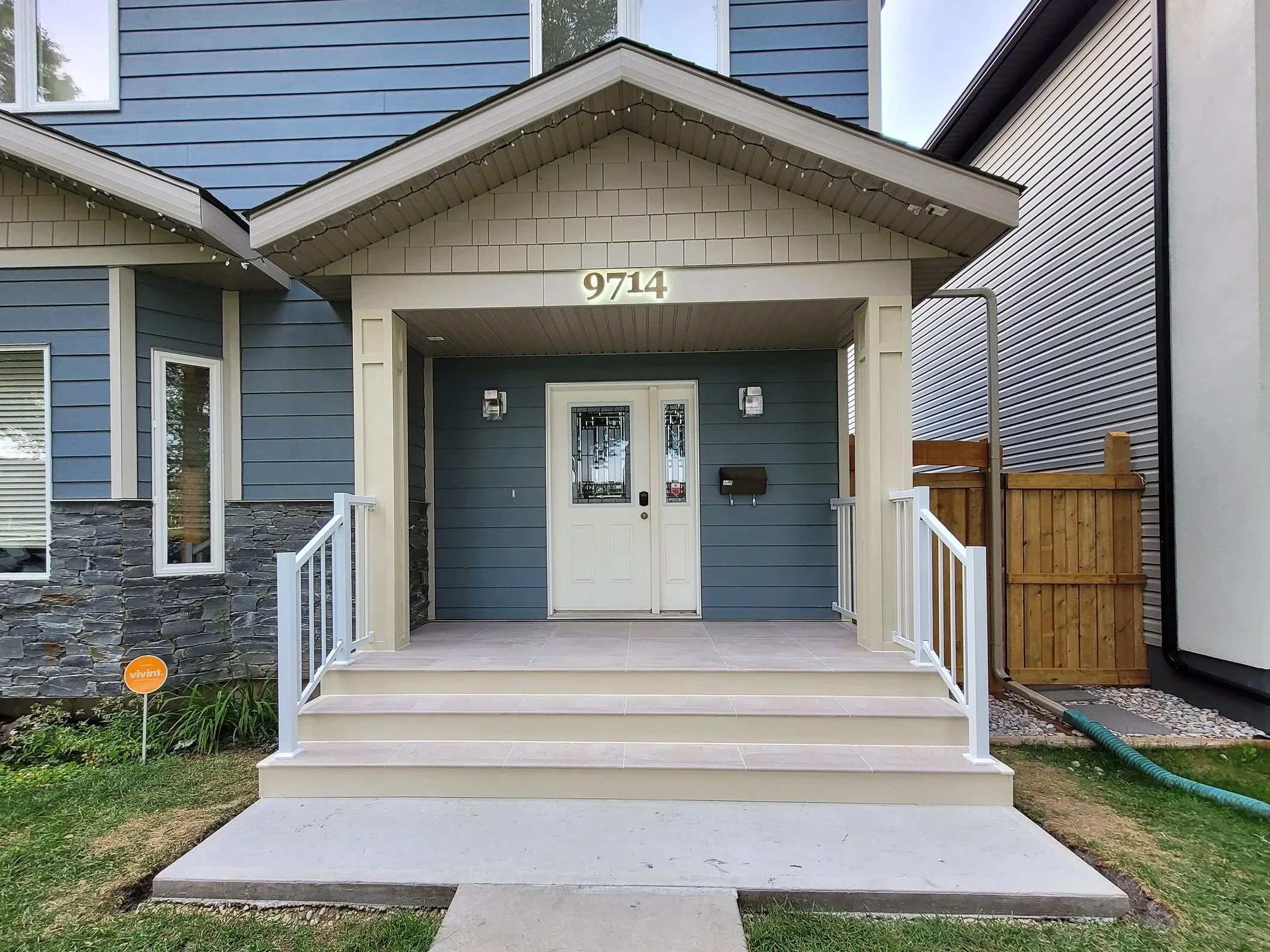 Custom porch, pillars, stairs, railings, concrete walkway 