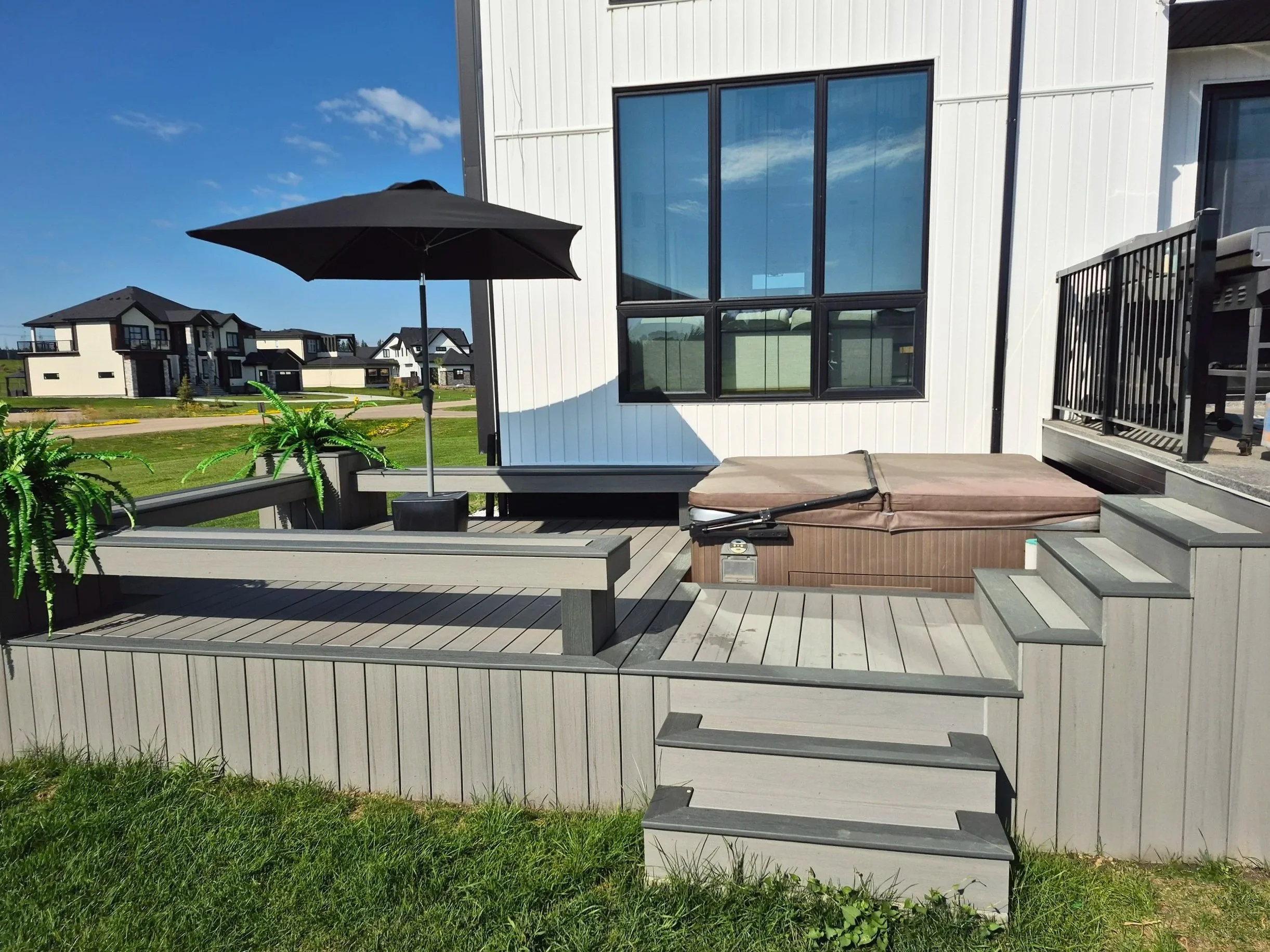 Custom composite deck with stairs and built-in benches, composite decking, hot tub deck