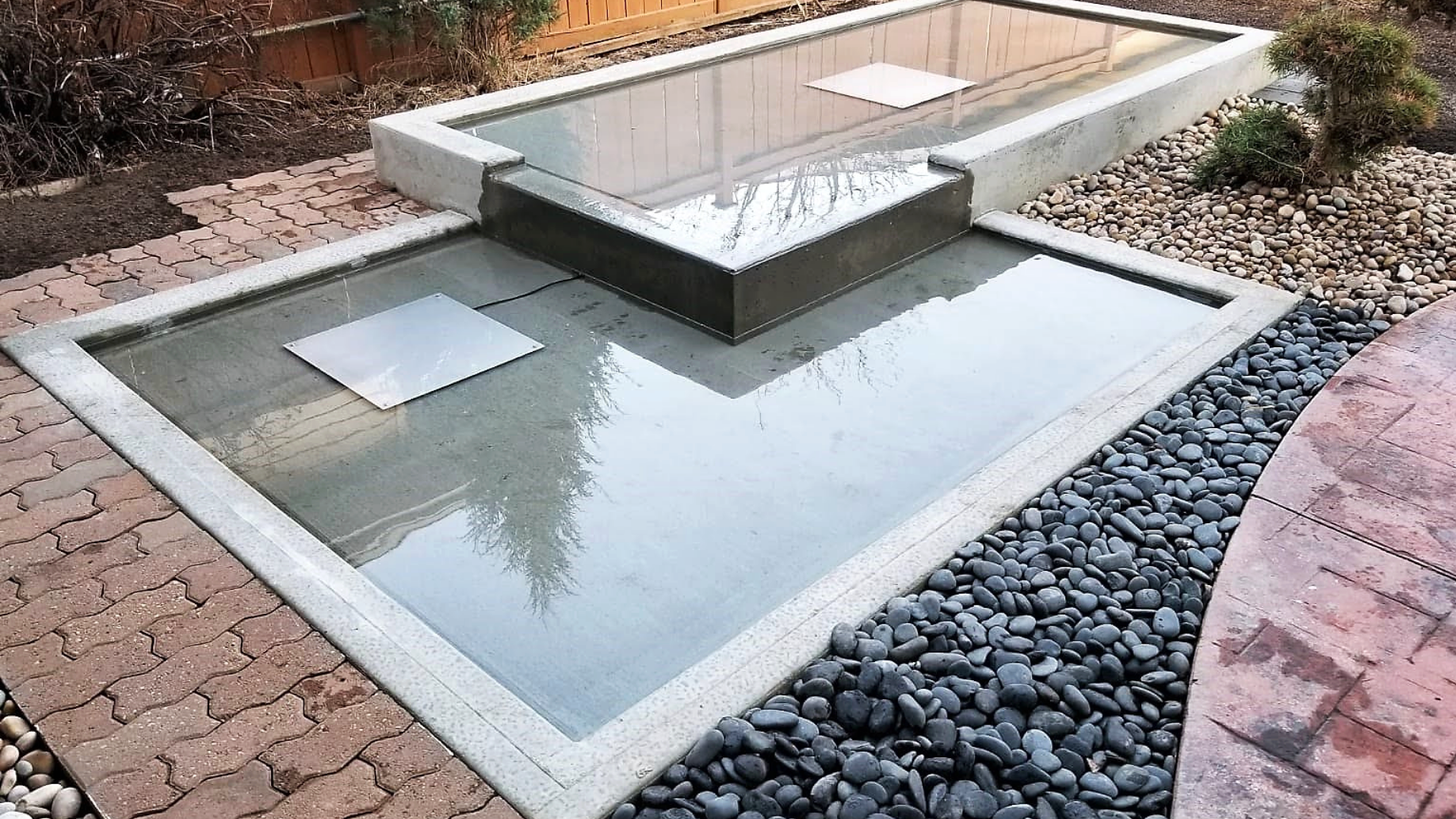 Custom water feature, fountain, pool,  paving stones, pavers, patio