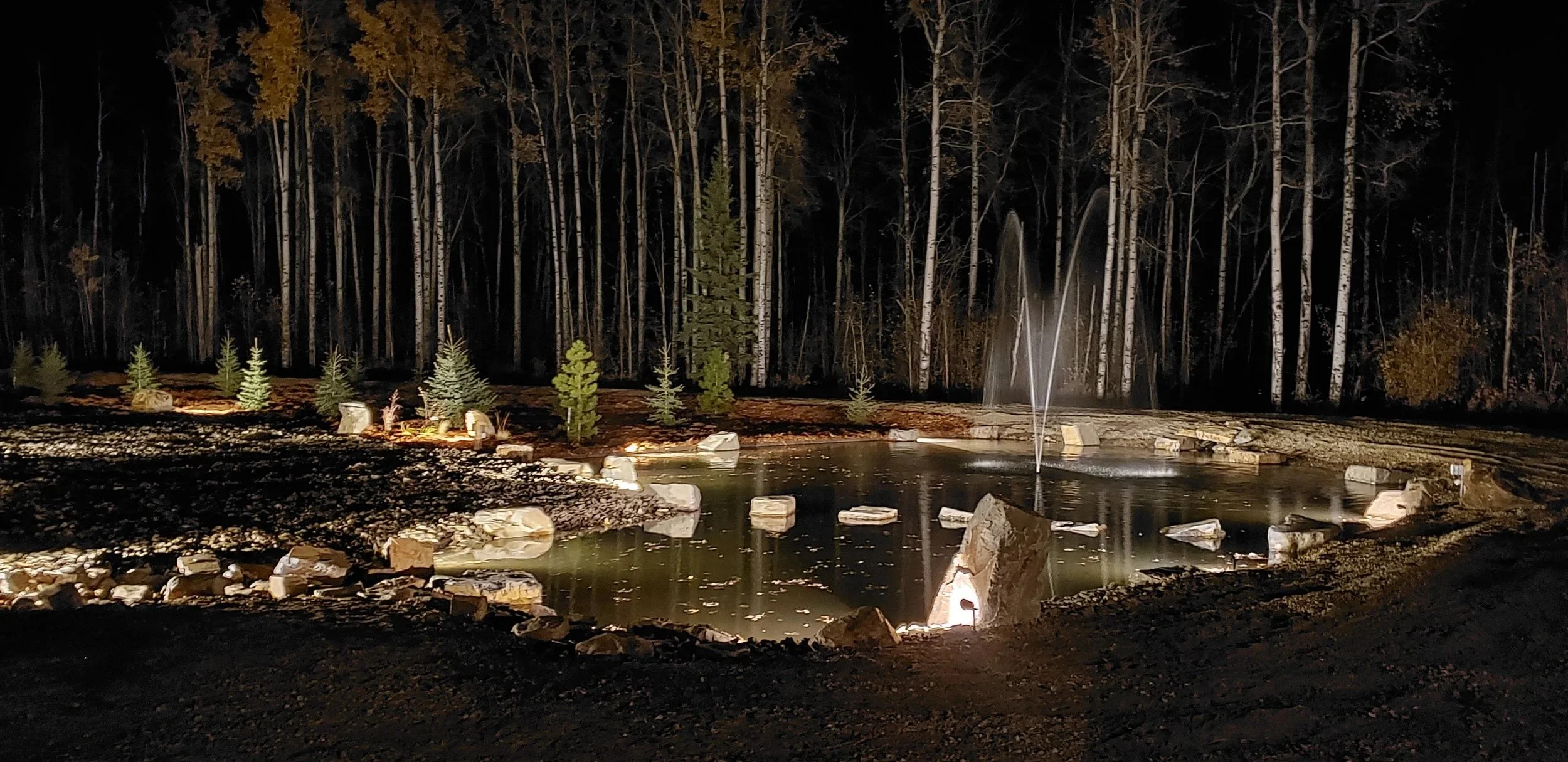 Custom artificial pond with decorative stones, water feature, fountain, landscaping