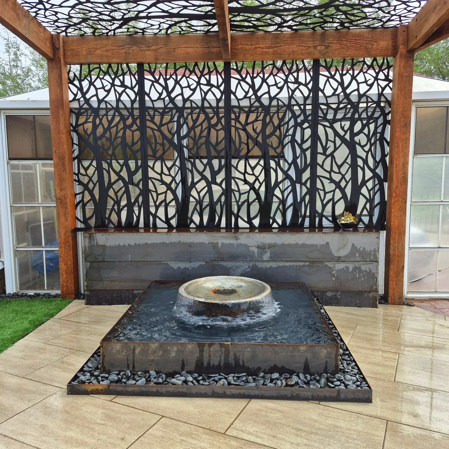 Custom water feature, fountain, wood and metal pergola, paving stones, pavers, patio