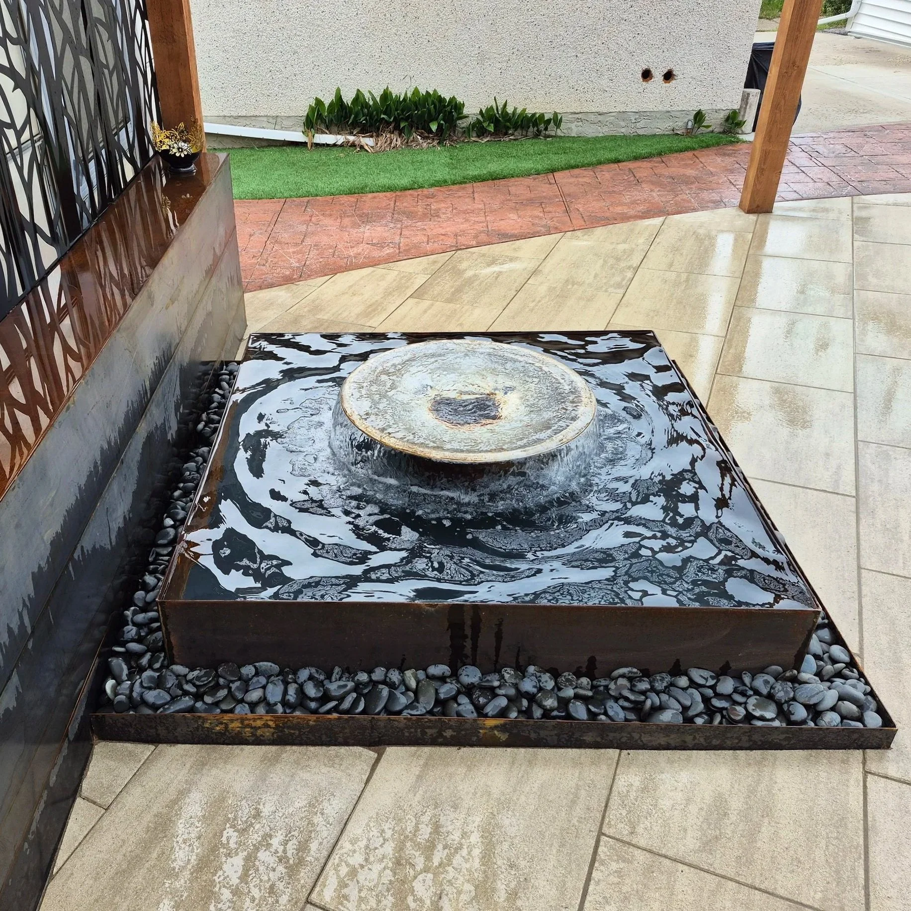 Custom water feature, fountain, wood and metal pergola, paving stones, pavers, patio