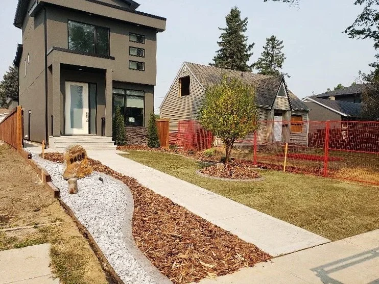 Concrete walkway, concrete patio, landscaping, decorative bark and stones