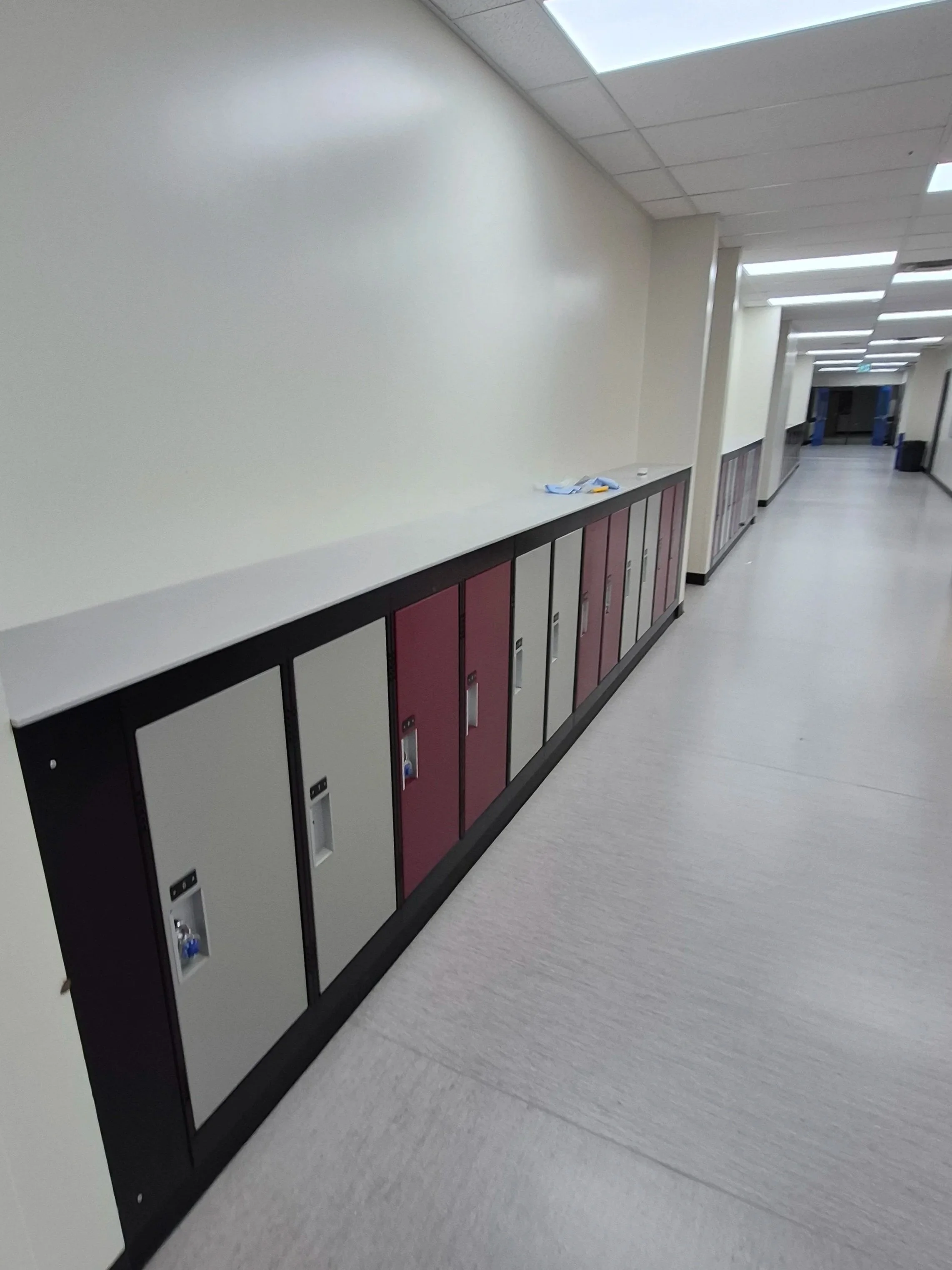 Interior renovation of a school hallway: walls, ceiling, floor, lockers installation