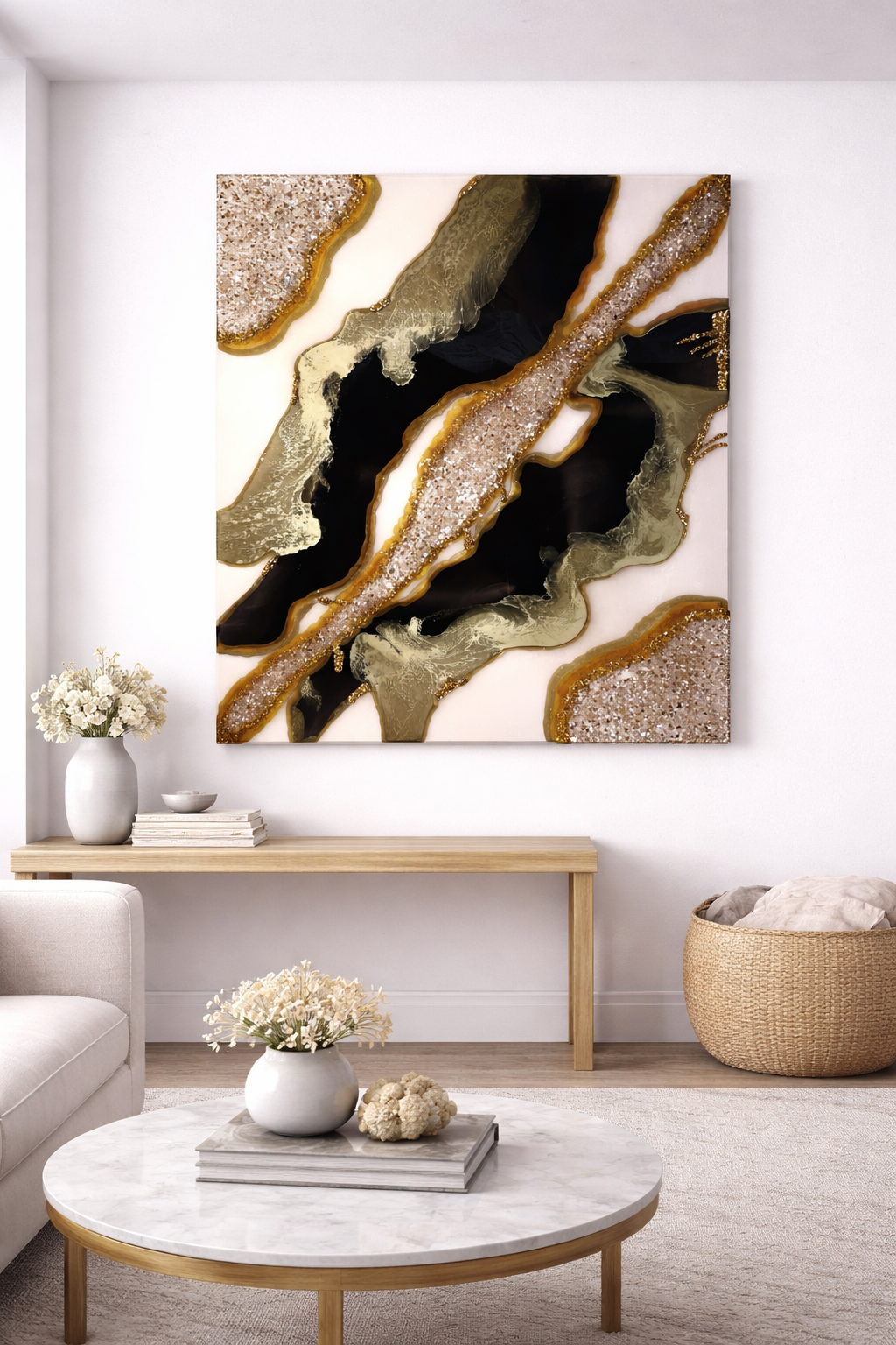 A large abstract wall art featuring black, gold, beige, and white swirls, with necklace-like glitter accents, hangs on a white wall in a modern living room.