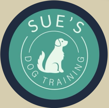 Logo for Sue's Dog Training featuring a sitting dog silhouette inside a circular emblem.