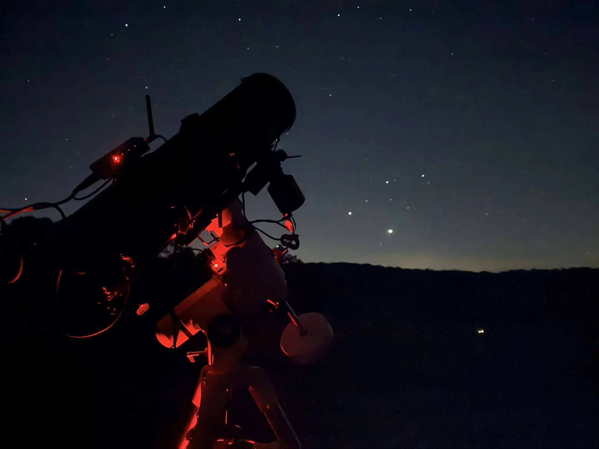 A night shot of the telescope pointed at a sky full of stars.