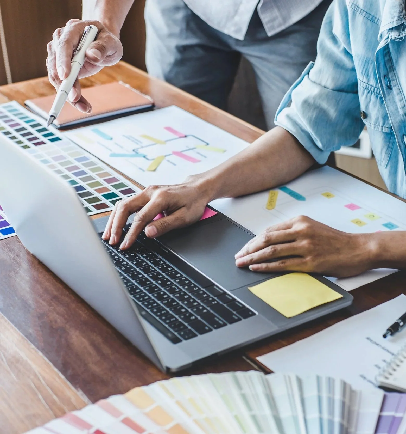 Image shows working on website design color schemes and scaling options for computer, laptop, tablet, and phone.