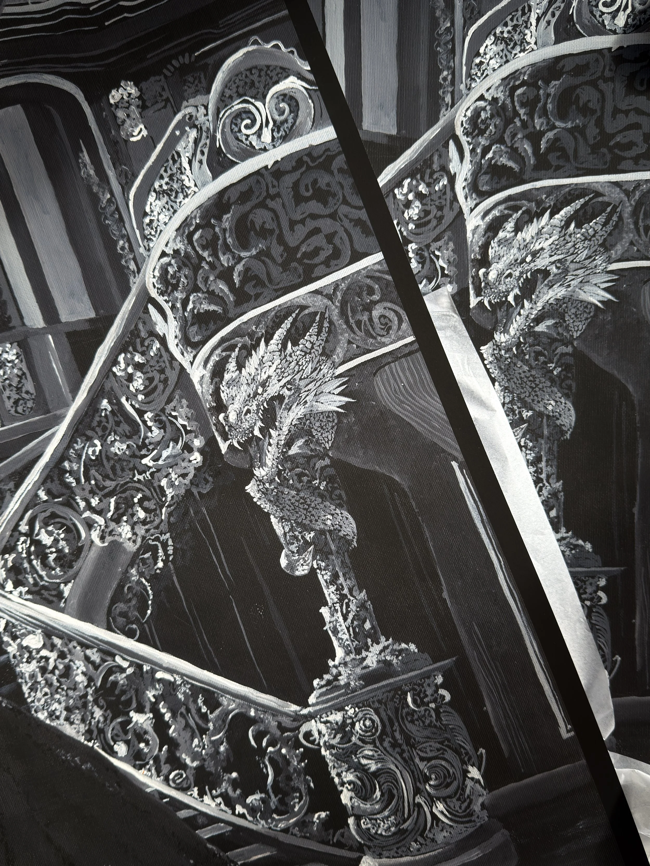 Black and white prints of an original fantasy painting- Calm Storms. The close up image is of dragon statues, carefully painted with lots of detail, swirling bannisters and textured palace architecture. The atmosphere is like ancient magic.