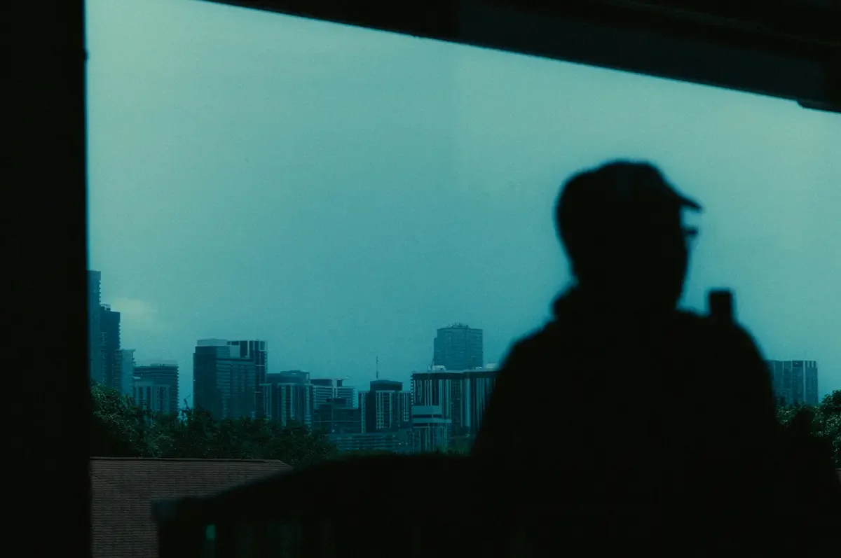 Person looking out at a city skyline