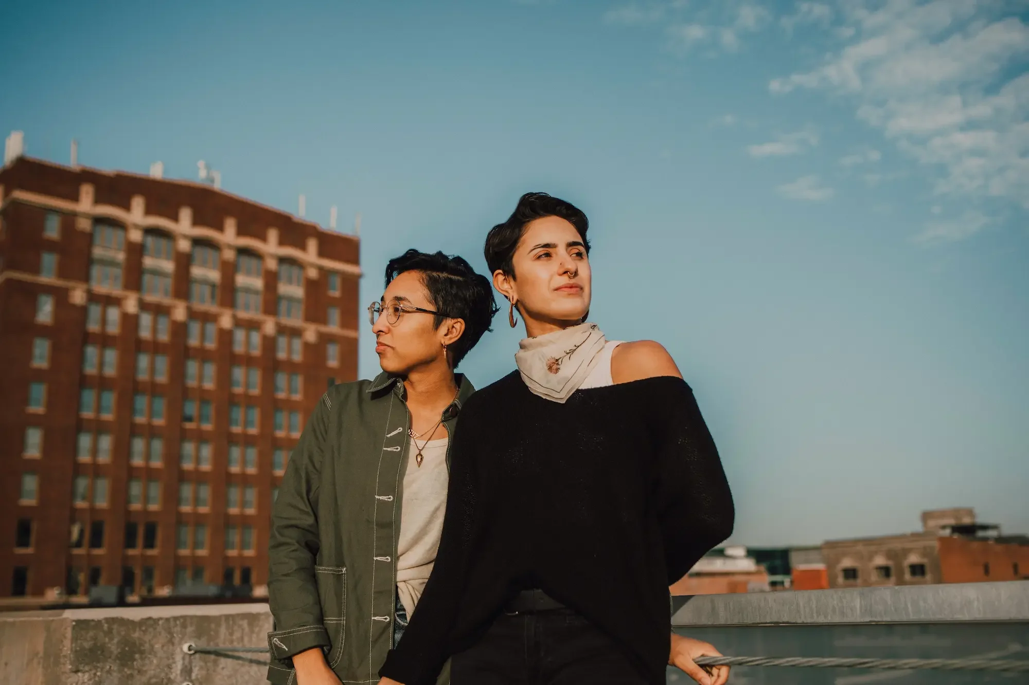 Queer couple standing together calmly, showing connection and emotional ease in their relationship in New York City