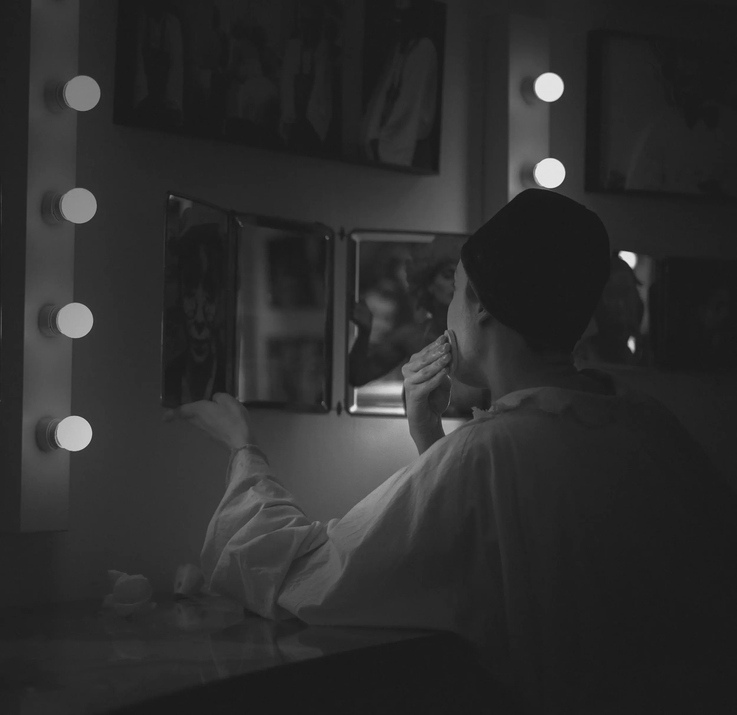 Artist in a dressing room mirror reflecting on identity and creative process, therapy for artists in New York City