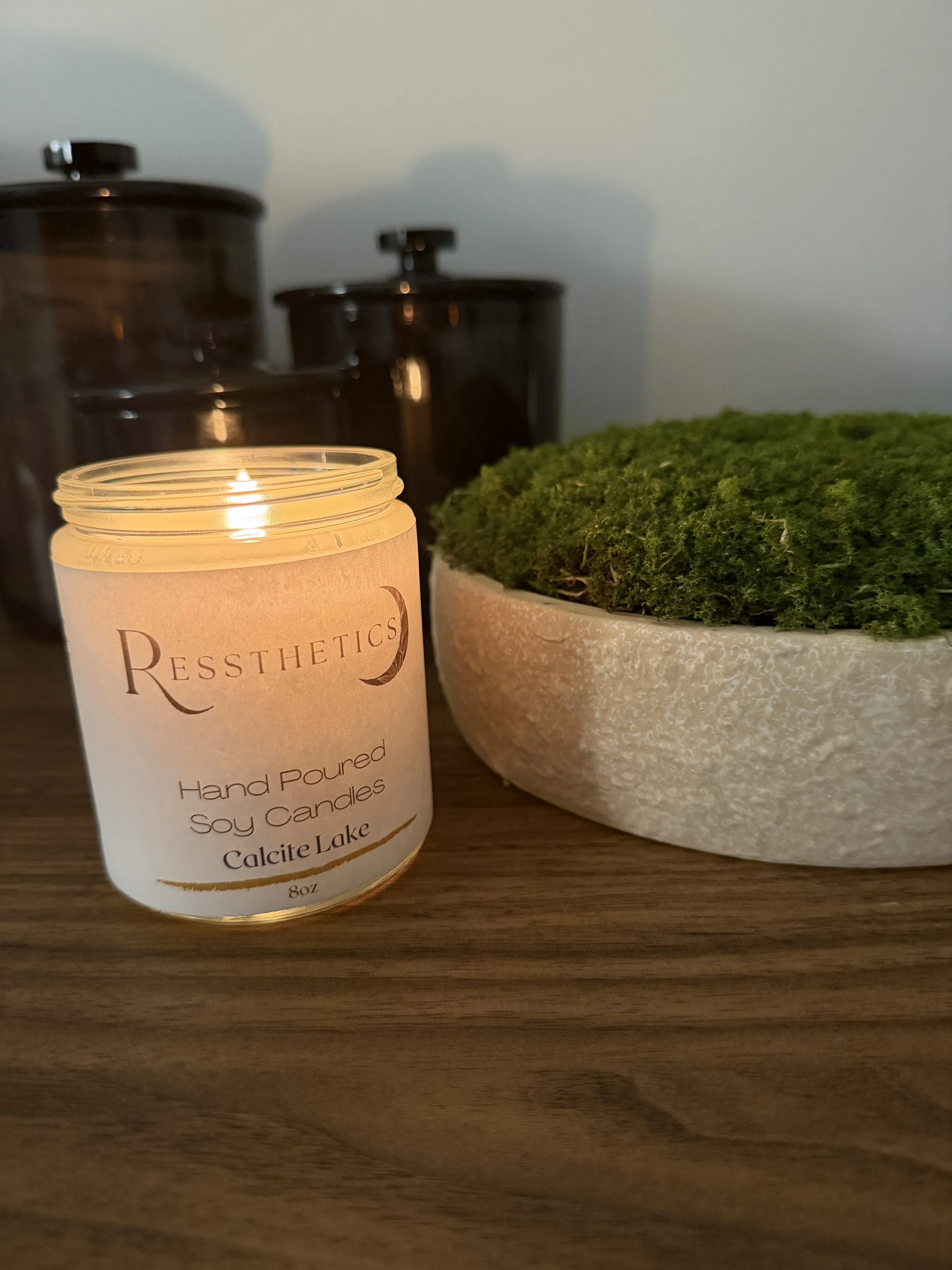 candle burning next to plant