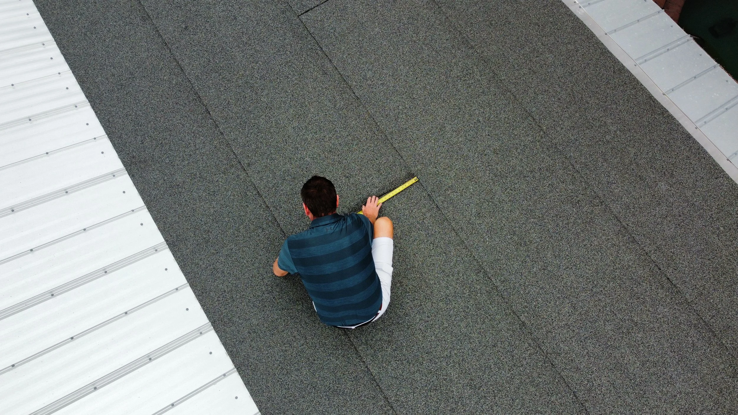 “Licensed contractor Brian Reamer measuring a homeowner’s roof during a wind mitigation inspection on the Treasure Coast.
