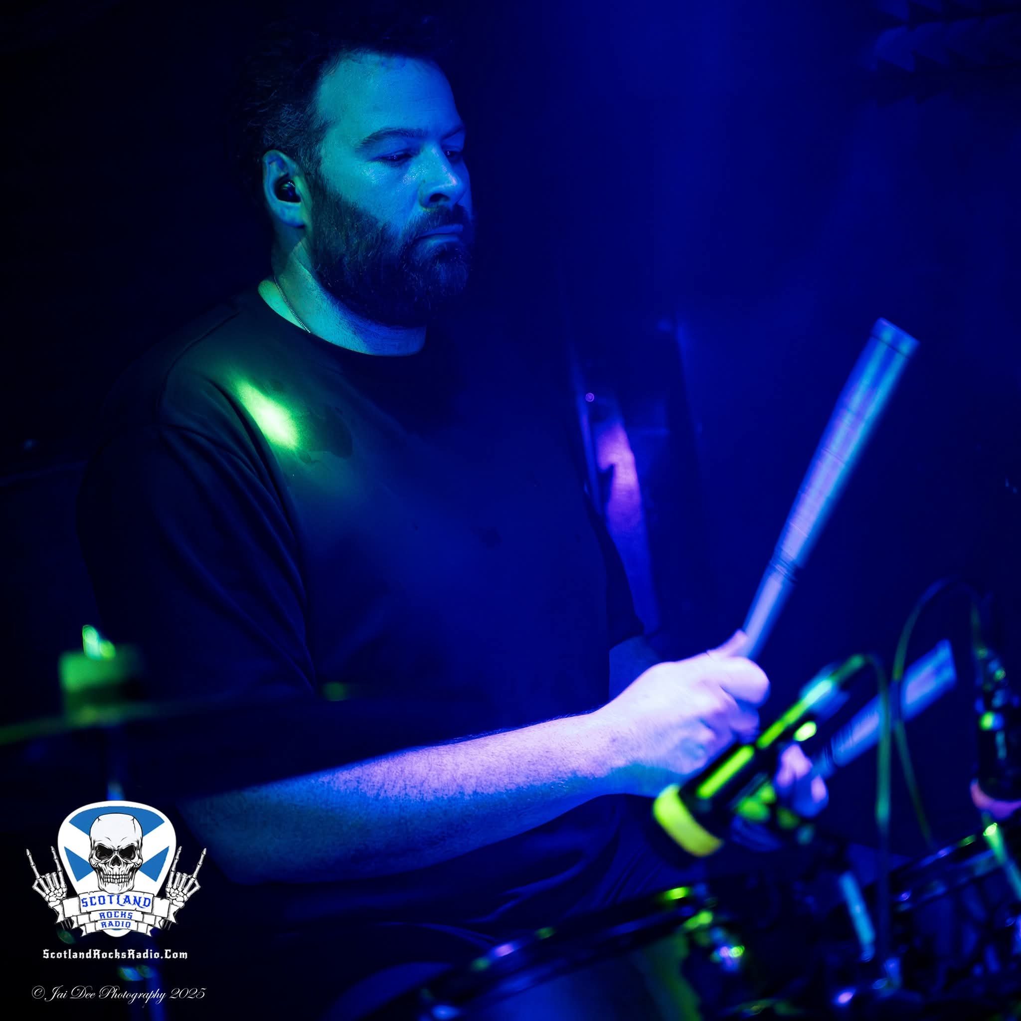 	
SOMB Scared of My Brother Drummer Arthur Kinnear-Kirkwood playing drums in a dark, neon-lit environment.