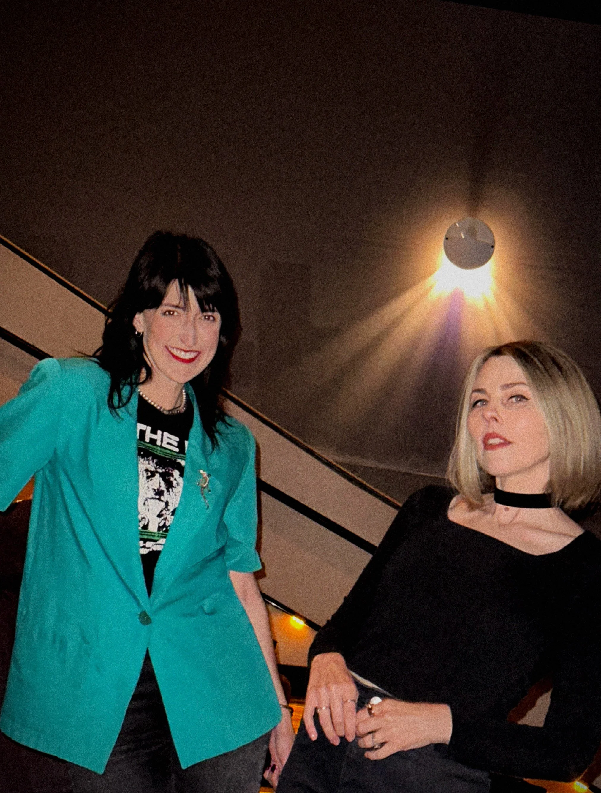 Portrait of Cinehaze film club founders Brittany Feenstra and Mickey Pangburn standing in a movie theater.